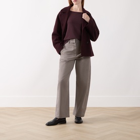 Model wearing Marc O Polo Stone Taupe wide-leg trousers, styled with a burgundy jacket and black loafers.