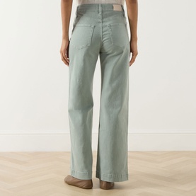 Model wearing Paige Wide Leg jeans in Vintage Seaglass, rear view showing high waist, five-pocket styling and relaxed wide-leg fit.