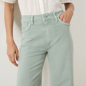 Model wearing Paige Wide Leg Jeans in Vintage Seaglass, cropped view showing braided pocket detail and relaxed fit.