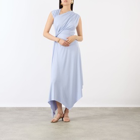 Model wearing Victoria Beckham Cloud Blue asymmetric midi dress with draped twist detail, styled with gold strappy heeled sandals.