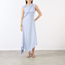 Model wearing Victoria Beckham Cloud Blue asymmetric draped midi dress, styled with strappy metallic sandals