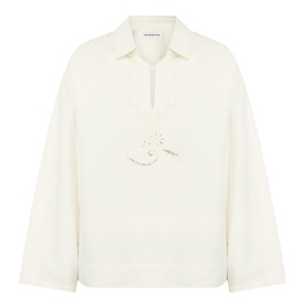 Victoria Beckham white collared top with half-zip placket, floral appliqu&eacute; detail, and wide long sleeves