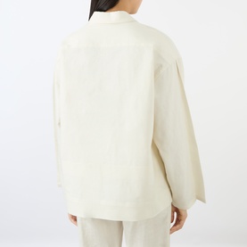 Model wearing Victoria Beckham white oversized top, rear view, with matching wide-leg trousers