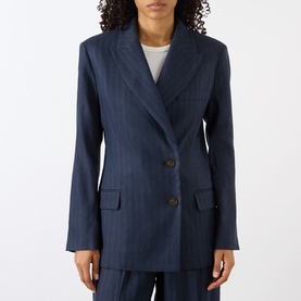 Model wearing Anine Bing navy pinstripe wool blazer, double-breasted with flap pockets, styled with matching wide-leg trousers