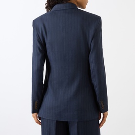 Model wearing Anine Bing navy pinstripe wool blazer, rear view, styled with matching navy trousers