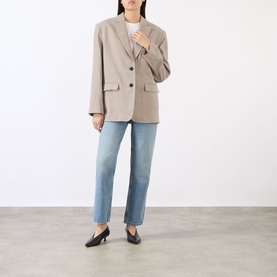 Model wearing Anine Bing linen blend blazer in taupe with blue straight-leg jeans and black kitten heel mules.