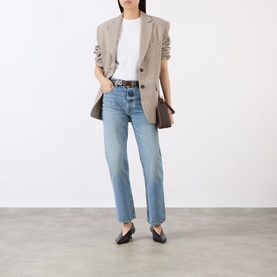 Model wearing Anine Bing linen-blend blazer in beige, styled with white tee, light-wash straight jeans, brown belt and black flats