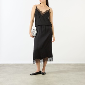 Model wearing Anine Bing Mael Lace-Trim Cami in black with lace hem skirt, styled with silver clutch and black ballet flats