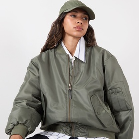 Model with Anine Bing Jeremy Logo Baseball Cap in Army Green, six-panel cotton construction with tonal embroidery, styled with olive bomber jacket