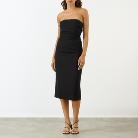 Model wearing Anine Bing black strapless midi dress with ruched bodice, styled with strappy heeled sandals.