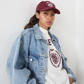 Model with Anine Bing Jeremy Logo Collegiate Baseball Cap in burgundy, styled with a white logo tee and oversized denim jacket.