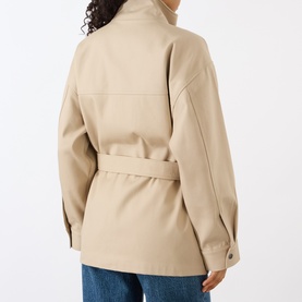 Model wearing Anine Bing Odin Utility Jacket in beige, showing rear view with buckle belt, dropped shoulders, and snap button cuffs, styled with jeans
