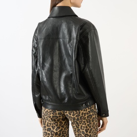Model wearing Anine Bing black leather jacket, rear view, styled with leopard-print trousers