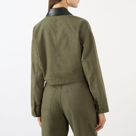 Model wearing Anine Bing Yuma Cropped Jacket in Army Green with black leather collar, styled with matching army green trousers, rear view