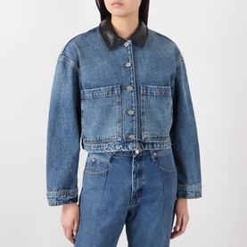Model wearing Anine Bing washed blue cropped denim jacket with black leather collar, silver buttons, and chest pockets, styled with matching denim
