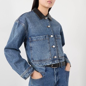 Model wearing Anine Bing washed blue denim jacket with black leather collar, styled with matching denim jeans and black belt.