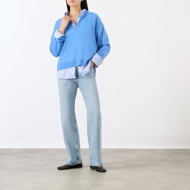 Model wearing Anine Bing blue cashmere knit sweater with light blue shirt underneath, paired with pale wash straight-leg jeans and black flats.