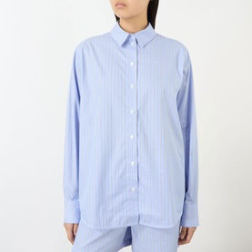 Model wearing Anine Bing Essie Striped Shirt in Washed Blue, relaxed fit with point collar, long sleeves and front button fastening.
