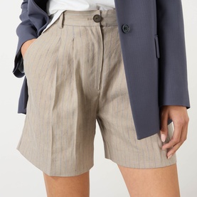 Model wearing Anine Bing shorts in multi, tailored fit with front pleats and button waist, styled with a navy blazer.