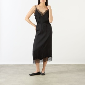 Model wearing Anine Bing black silk-blend slip skirt with lace hem trim, styled with matching lace cami top and black ballet flats.