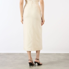 Model wearing Anine Bing cream midi skirt, back view, styled with black strappy heels