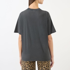 Model wearing Anine Bing washed black oversized T-shirt, back view, styled with leopard print trousers.