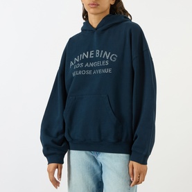 Model wearing Anine Bing navy cotton hoodie with Los Angeles Melrose Avenue logo print, styled with light blue jeans