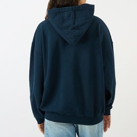 Model wearing Anine Bing navy cotton hoodie sweat top, back view, styled with light blue jeans