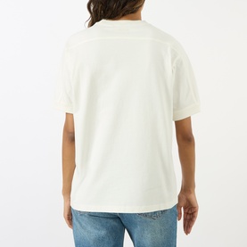Model wearing Anine Bing ecru cotton T-shirt, back view, styled with light blue denim jeans.