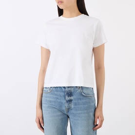 Model wearing Anine Bing white cotton T-shirt with crew neck and short sleeves, styled with light blue denim jeans.