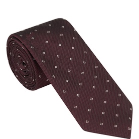Calvin Klein burgundy silk tie with small white dot pattern, rolled to show texture and width