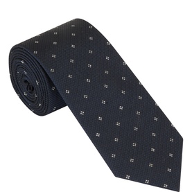 Calvin Klein navy silk tie with small white square dot pattern, rolled to show texture and weave detail