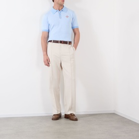 Model wearing Casablanca Pinstripe Logo Polo Shirt in light blue with cream trousers, brown leather belt and loafers