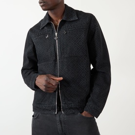 Model wearing Casablanca black quilted cotton zip-up jacket with diamond pattern, styled with grey denim jeans.