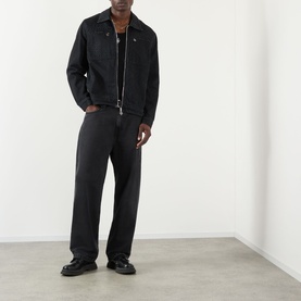 Model wearing Casablanca black cotton zip-up jacket with dark trousers and black loafers.