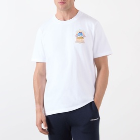 Model wearing Casablanca Classic Logo Graphic T-Shirt in white with Egyptian Arch chest graphic, paired with navy joggers.