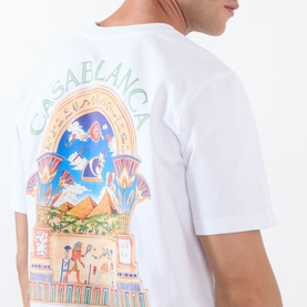 Model wearing Casablanca Classic Logo Graphic T-Shirt in white with Egyptian Arch graphic print visible on back. Short sleeves, round neckline.