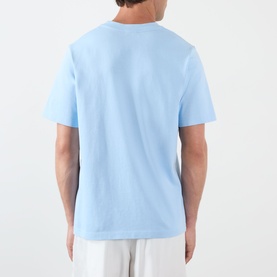 Model wearing Casablanca Egyptian Tennis Match Logo T-Shirt in light blue, back view, crew neck, dropped shoulders, short sleeves, straight hem.