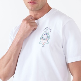 Model wearing Casablanca Classic Logo Graphic T-Shirt in white with Hotel Emblem graphic print at chest, round neckline, short sleeves