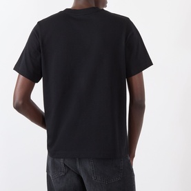 Model wearing Casablanca Tennis Club Icon Pyramid Abduction T-Shirt in black, rear view, short sleeves, straight hemline, styled with dark jeans.