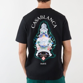 Model wearing Casablanca Hotel Emblem black cotton T-shirt, back view showing graphic print with Paris text and ornate emblem design.