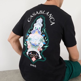 Model wearing Casablanca Hotel Emblem T-Shirt in black, back view showing large graphic print with ornate lantern and Paris branding