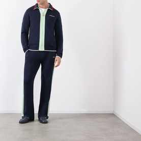 Model wearing Casablanca Logo Merino Wool Track Jacket in navy with contrast stripe detail, styled with matching navy track trousers and dark shoes.