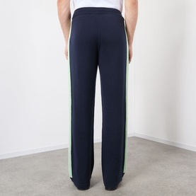Model wearing Casablanca Logo Merino Wool Track Pants in navy with green and sage contrast side stripes, straight-cut leg, rear view