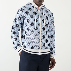 Model wearing Casablanca Monogram Logo Zip Sweatshirt in CC Monogram print, light blue with navy logo pattern, ribbed contrast trims, styled with