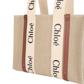 Chloe Woody Tote in white brown canvas with logo-stripe handles and rust-red zip detail, gold-tone hardware visible