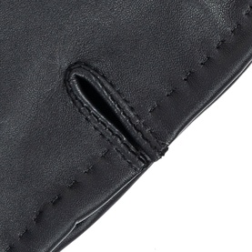 Dents black leather gloves close-up showing contrast stitching detail and thumb opening on smooth leather surface