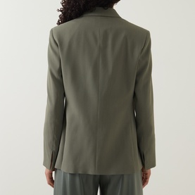 Model wearing Hugo Boss blazer in khaki green, rear view, single vent, long sleeves, styled with matching trousers
