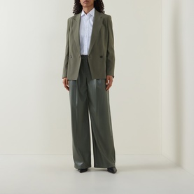 Model wearing Hugo Boss blazer in khaki green, styled with matching wide-leg trousers and a white shirt