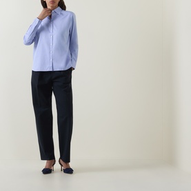 Model wearing Hugo Boss light pastel purple cotton blouse with dark navy tailored trousers and navy slingback heels.